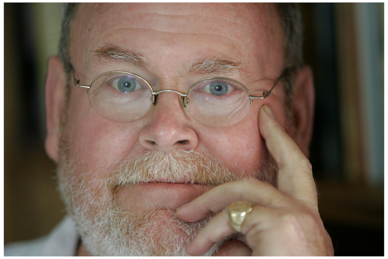 Man's spectacled face looking at the camera