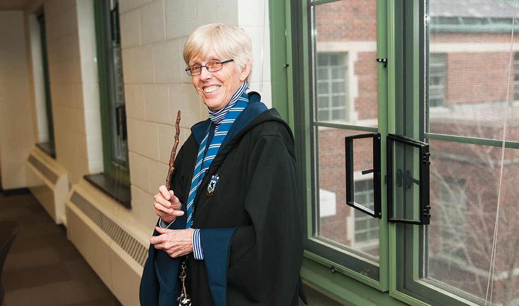 woman in ravenclaw regalia with wand